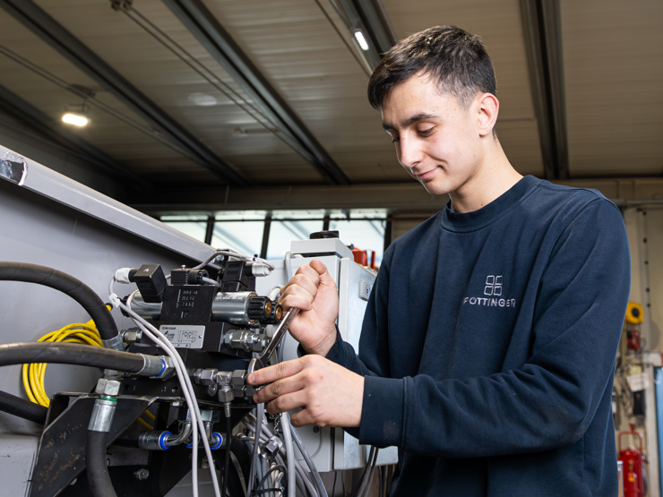 Lehrling bei der Montage einer Hydraulikanlage